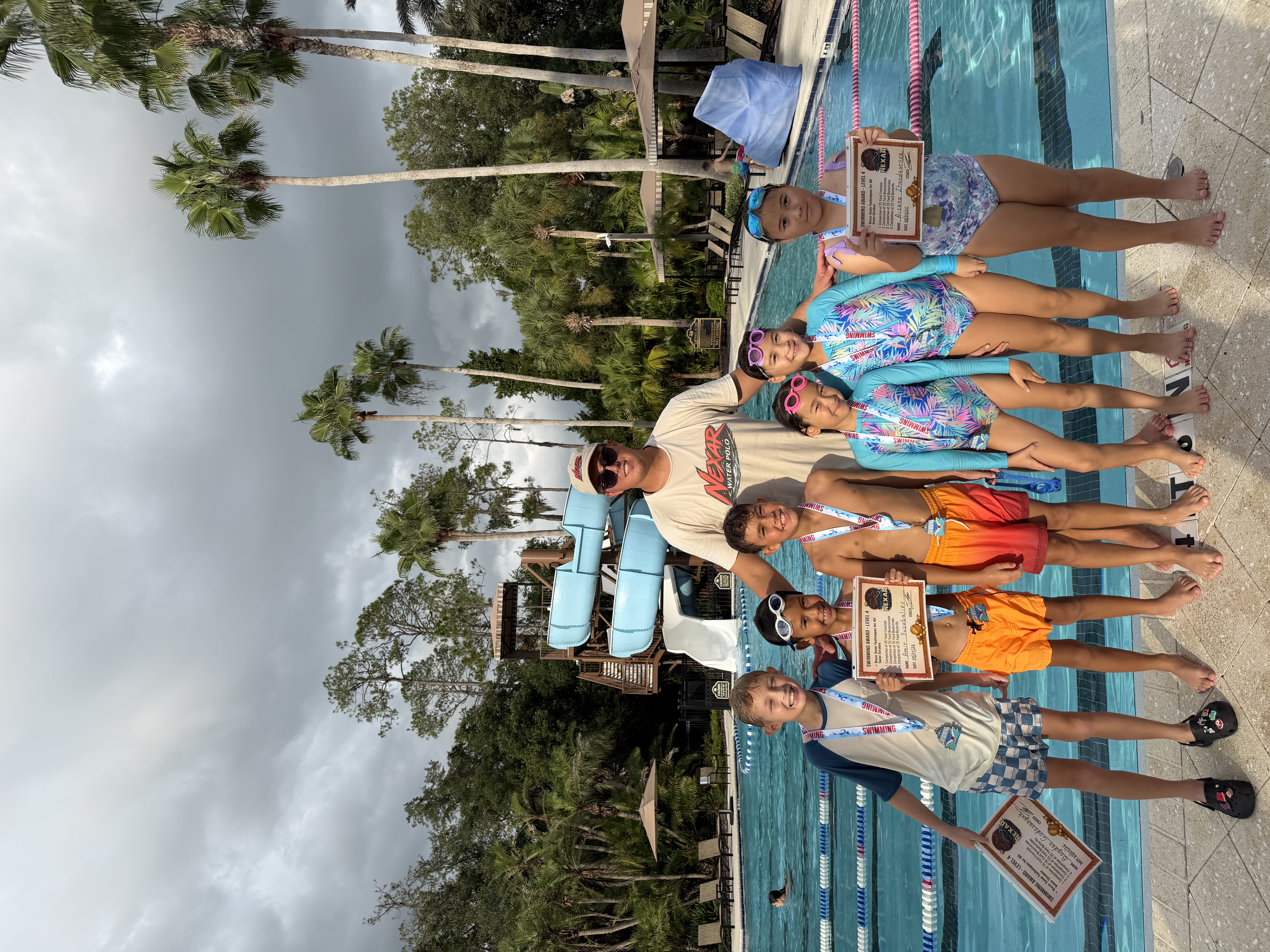 NEXAR Swim Team athletes with Coach Alex